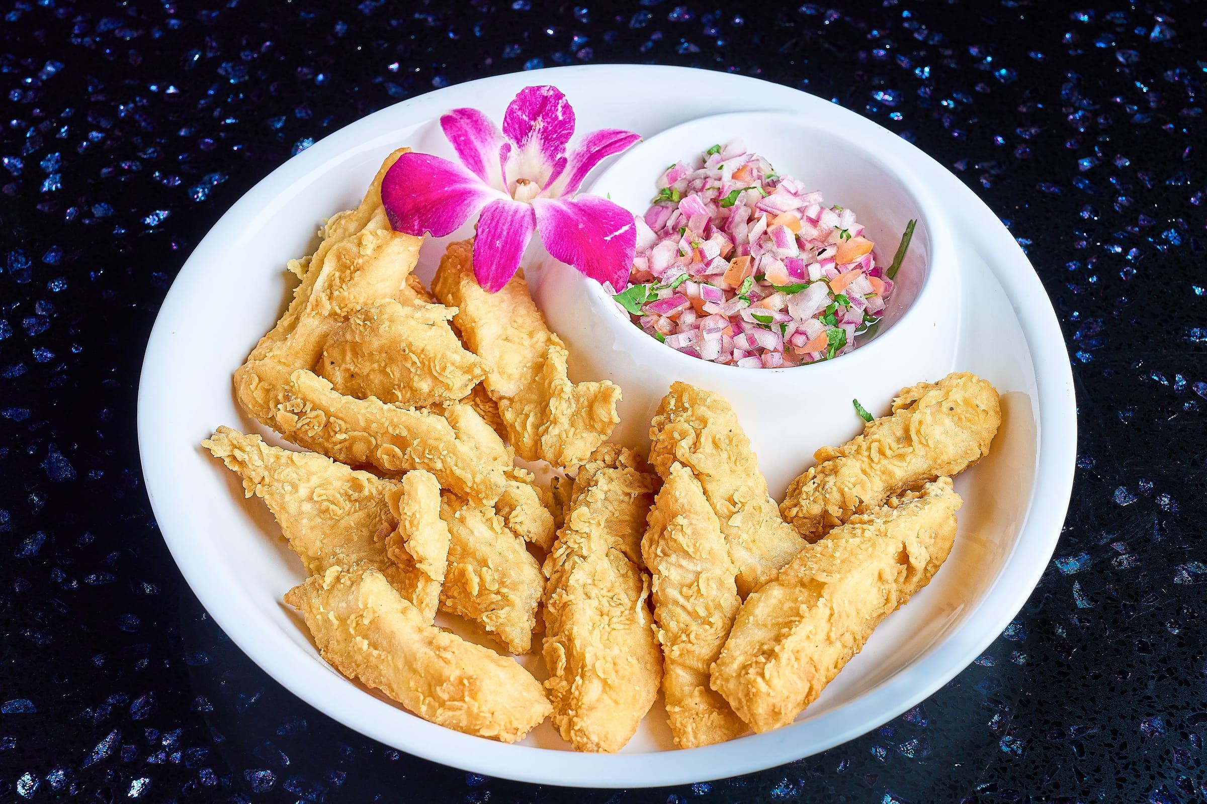 Fried fish chicharron with red onion salad