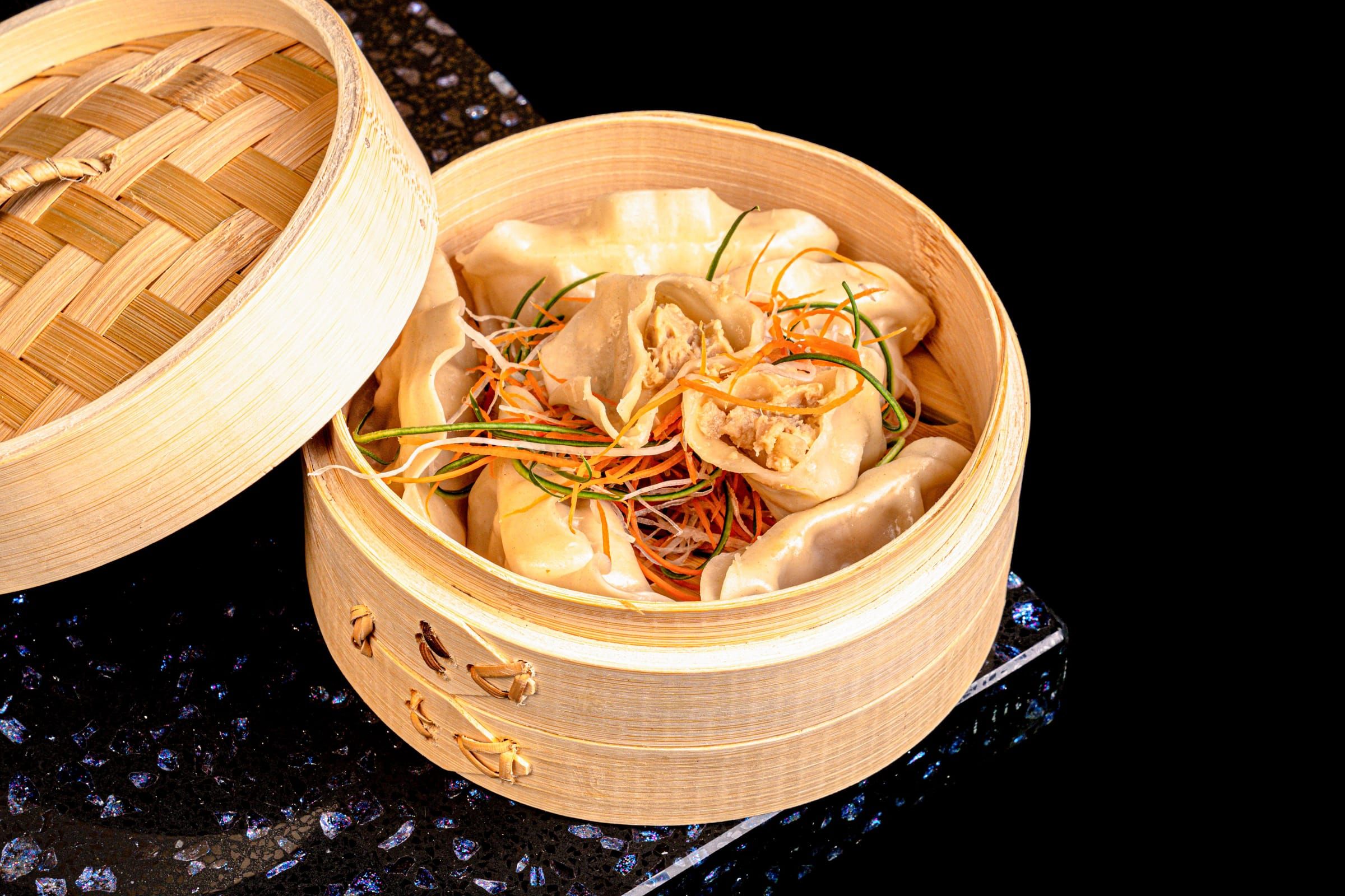 Steamed dumplings in a bamboo basket