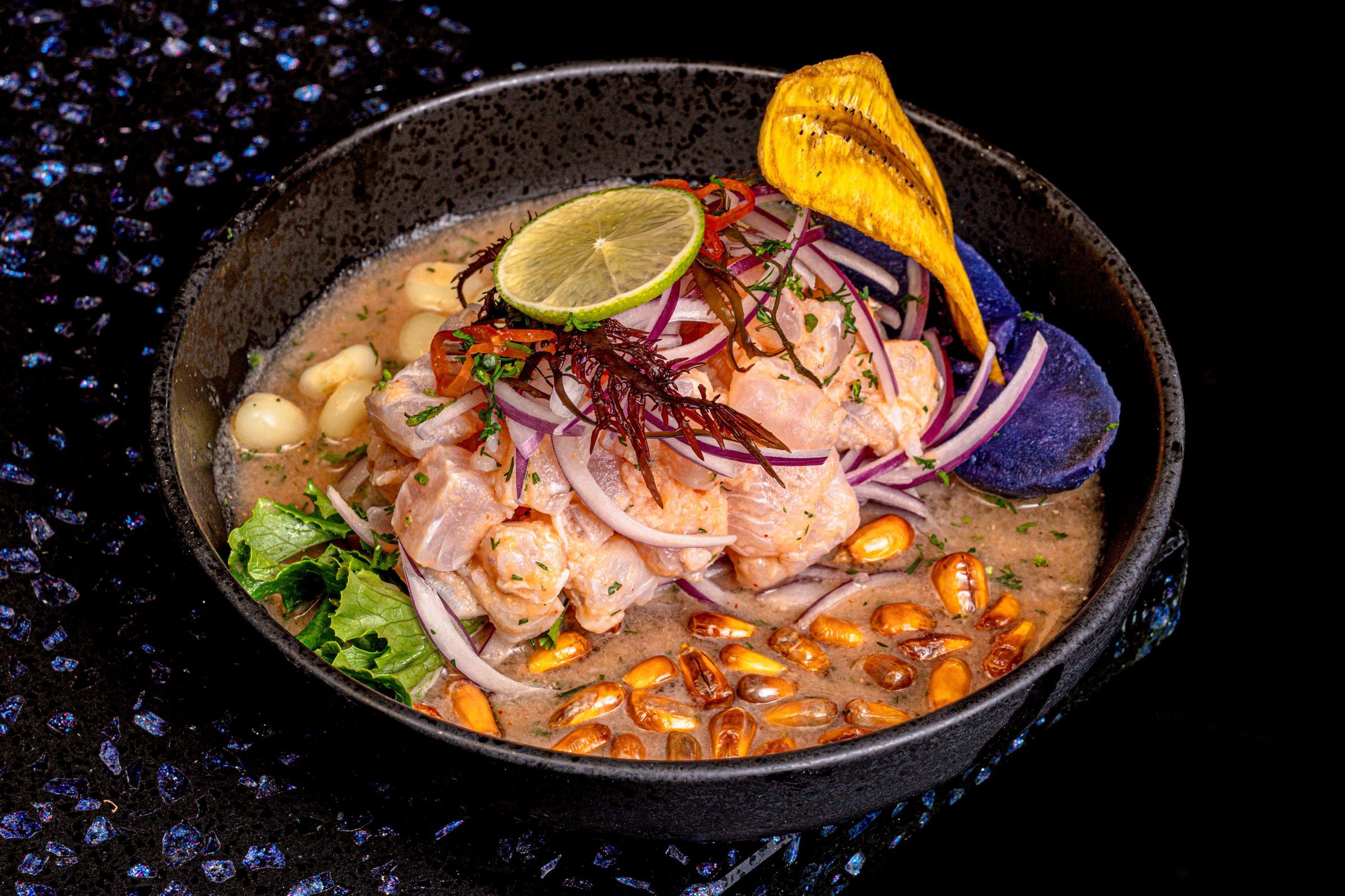 Fish ceviche with red onion, corn, and sweet potato