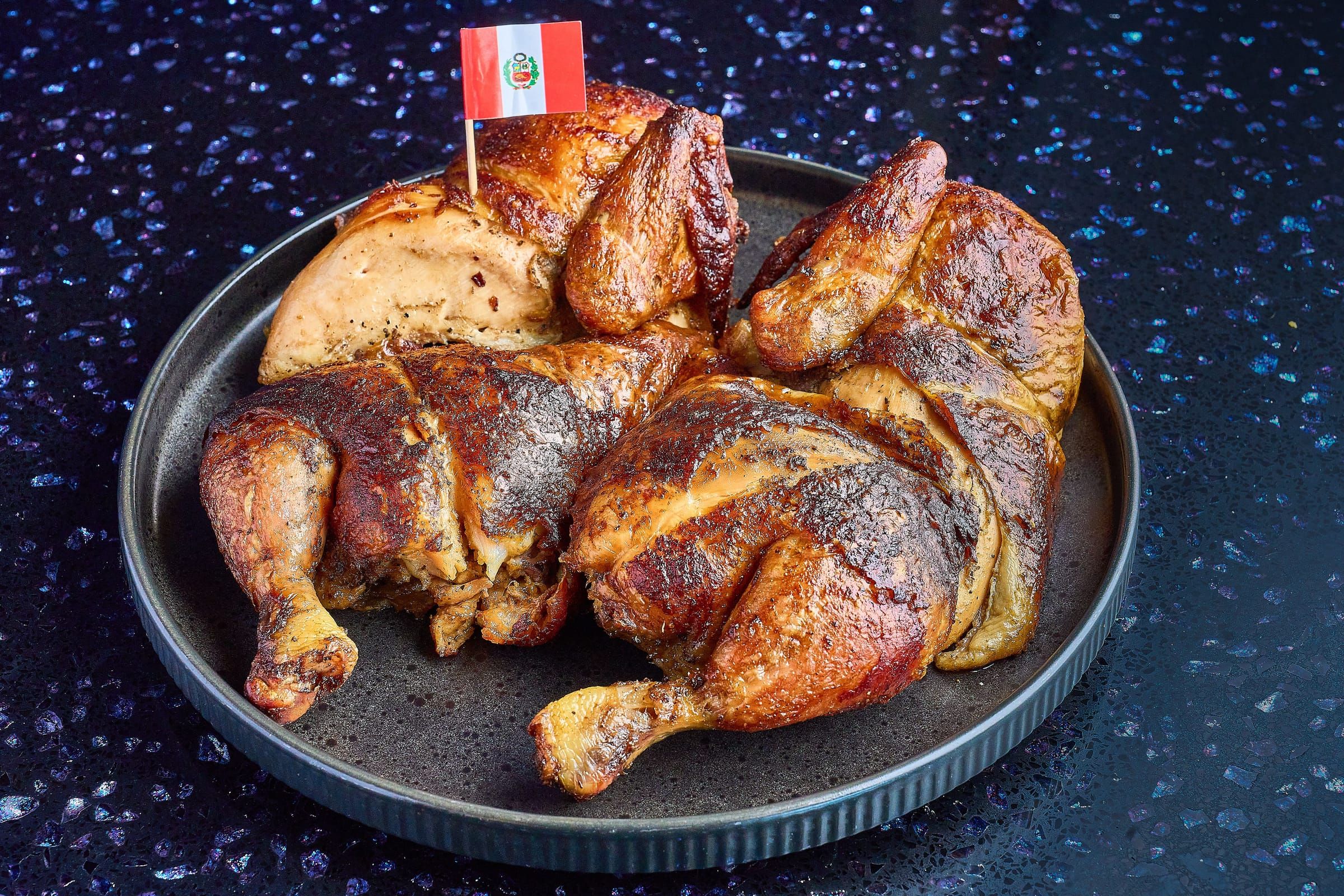 A whole charcoal-roasted pollo a la brasa with chaufa, fries, and salad at Blaze on Fire